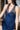 A navy blue chemise with lace detailing under the bust and a stretch-lace racerback, worn by a model.