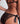 Close-up of black sheer lace mini brief with satin ribbon bow tie at the hip