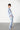 model wearing the Bently cotton pajama set in blue with white stripes by Pluto with a button-up shirt and matching pants