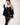 Model wearing black strappy Angela dress with mesh and 24k gold zip