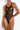 Model wearing the Bordelle Zenna Halter-Neck Body in black featuring sheer Italian mesh, a halter neckline, satin elastic straps, and 24k gold hardware.