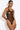 Model wearing the Bordelle Zenna Halter-Neck Body in black featuring sheer Italian mesh, a halter neckline, satin elastic straps, and 24k gold hardware.