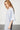 model wearing the Caite cotton gown in blue by Pluto with a crew neckline, relaxed fit and floral lace-style detailing