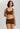 Classic seamless brown sports bra in soft ribbed fabric with light support and smooth fit, perfect for everyday comfort.