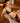 Model wearing Desir Et Volupte non-wired triangle bra with floral embroidery and gold clasp in black.