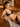 Model wearing Desir Et Volupte non-wired triangle bra with floral embroidery and gold clasp in black.