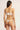 back view of model wearing the Else Bella thong with minimal coverage and string sides in ivory