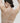 Essentiel nude seamless strapless bra with underwire and molded cups, microfiber comfort, and multi-way straps for versatile styling.