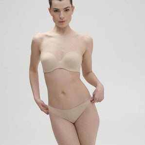 Essentiel nude seamless strapless bra with underwire and molded cups, microfiber comfort, and multi-way straps for versatile styling.