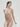 Essentiel nude seamless strapless bra with underwire and molded cups, microfiber comfort, and multi-way straps for versatile styling.