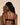 Forte black wireless bralette with French floral lace, plunge neckline, scalloped edges, and soft triangle cups for a bold, feminine look.