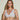 Forte white wireless bralette with French floral lace, plunge neckline, scalloped edges, and soft triangle cups for a bold, feminine look.