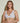 Forte white wireless bralette with French floral lace, plunge neckline, scalloped edges, and soft triangle cups for a bold, feminine look.