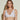 Forte white wireless bralette with French floral lace, plunge neckline, scalloped edges, and soft triangle cups for a bold, feminine look.