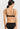 HANRO Satin Deluxe black soft cup T-shirt bra in silky viscose with plunge neckline, padding, and matte gold hardware.
