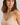 HANRO beige seamless V-neck camisole in mercerized cotton with satin trim and adjustable straps, perfect for layering or wearing alone.