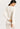 Back view of model wearing a women’s wool-silk long-sleeve thermal top in cygne by Hanro.