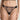Model wearing the I.D. Sarrieri Love Potion Thong in black featuring embroidered lace, sheer mesh, a low-rise fit, and minimal coverage.