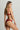 Model wearing the Memories of Love thong by I.D. Sarrieri in dark red with minimal coverage