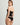Back view of black bustier showing sheer mesh panel and zip closure