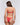 Back view of model wearing red lace Italian briefs with minimal back coverage and orange straps