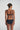 Marie Jo Rio briefs in black with feather-light fabric, seamless back, Brazilian cut, and elegant pearl strap detail.