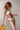 Marie Jo Rio briefs in white with feather-light fabric, seamless back, Brazilian cut, and elegant pearl strap detail.