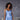Model wearing Marjolaine Betty Silk Satin Slip in Bleu Ciel showing V-neckline and flowing silk drape