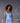 Model wearing Marjolaine Betty Silk Satin Slip in Bleu Ciel showing V-neckline and flowing silk drape