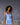 Model wearing Marjolaine Betty Silk Satin Slip in Bleu Ciel showing V-neckline and flowing silk drape