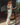 Back view of Marjolaine Carmela Long Dress featuring an open-back silk satin design in white and silver.