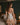 Back view of the Marjolaine Daisy Floral Silk Nightdress in nude showcasing the floral lace back, stretch silk satin, adjustable spaghetti straps, delicate floral print, and an elegant above-the-knee fit.