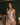 Model wearing the Marjolaine Daisy Floral Silk Nightdress in beige with a delicate floral print, stretch silk satin, floral lace trim, adjustable spaghetti straps, and an above-the-knee silhouette.
