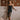 Model wearing the Marjolaine Daniella silk nightdress in black with a floral lace hem.