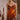 Woman wearing the Marjolaine Diane Dentelle Silk Nightdress in burnt orange with burgundy floral lace.