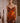 Woman wearing the Marjolaine Diane Dentelle Silk Nightdress in burnt orange with burgundy floral lace.