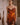 Woman wearing the Marjolaine Diane Dentelle Silk Nightdress in burnt orange with burgundy floral lace.