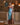 Woman wearing the Marjolaine Diane Long Silk Nightdress in aqua blue with burgundy floral lace and a high side slit.