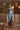 Woman wearing the Marjolaine Diane Long Silk Nightdress in aqua blue with burgundy floral lace and a high side slit.