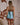 Back view of the Marjolaine Diane turquoise silk mini nighty with burgundy lace detailing and adjustable spaghetti straps.