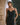 Model wearing the Marjolaine Tess Long Silk Nightdress in black featuring smooth silk satin, floral lace neckline, adjustable spaghetti straps, an ankle-length silhouette, and a side slit.