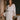 Model wearing the Marjolaine Tess Short Silk Robe in ivory featuring smooth silk satin, floral lace cuffs, a wrap-front design, long sleeves, and a self-tie waist belt.