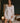 Model wearing the Marjolaine Tess Short Silk Robe in ivory featuring smooth silk satin, floral lace cuffs, a wrap-front design, long sleeves, and a self-tie waist belt.