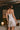 Back view of the Marjolaine Tess Silk Nighty in ivory showcasing smooth silk satin, delicate floral lace back detail, adjustable spaghetti straps, and a feminine above-the-knee fit.