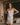 Model wearing the Marjolaine Tess Silk Nighty in ivory featuring smooth silk satin, floral Calais lace at the neckline and hem, adjustable spaghetti straps, and an elegant above-the-knee silhouette.