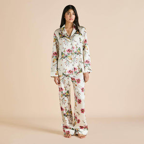 Silk long pajama set in Maugham floral print with pearl buttons, olive piping, and a notched collar for timeless luxury and comfort.