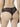 Back view of model wearing black NUEAME Brazilian Flower Lace Briefs showing sheer floral lace back and scalloped edges.