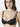 Model wearing black NUEAME Underwire Lace Balcony Bra with floral lace cups and double straps.