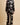 Back view of the Olivia von Halle Lila Rene Black Blossom silk pajama set showcasing the elegant Blossom floral print on black silk satin with ivory piping.