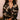 Model wearing the Olivia von Halle Lila Rene Black Blossom silk pajama set featuring the exclusive Blossom floral print on black silk satin with ivory contrast piping.